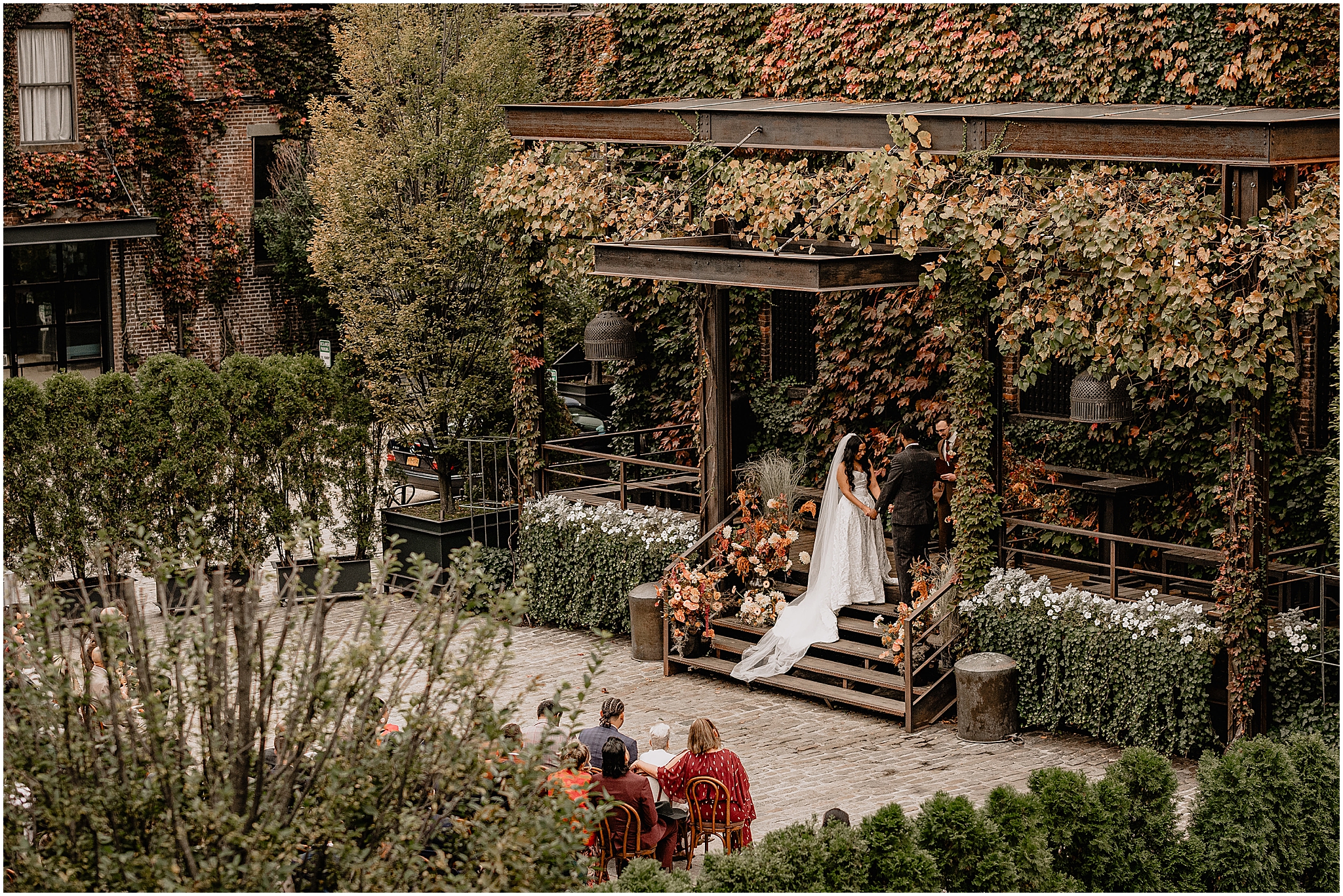 Couple at the altar during their Intimate Fall Wedding at The Foundry LIC, exchanging vows amidst the stunning autumn backdrop.