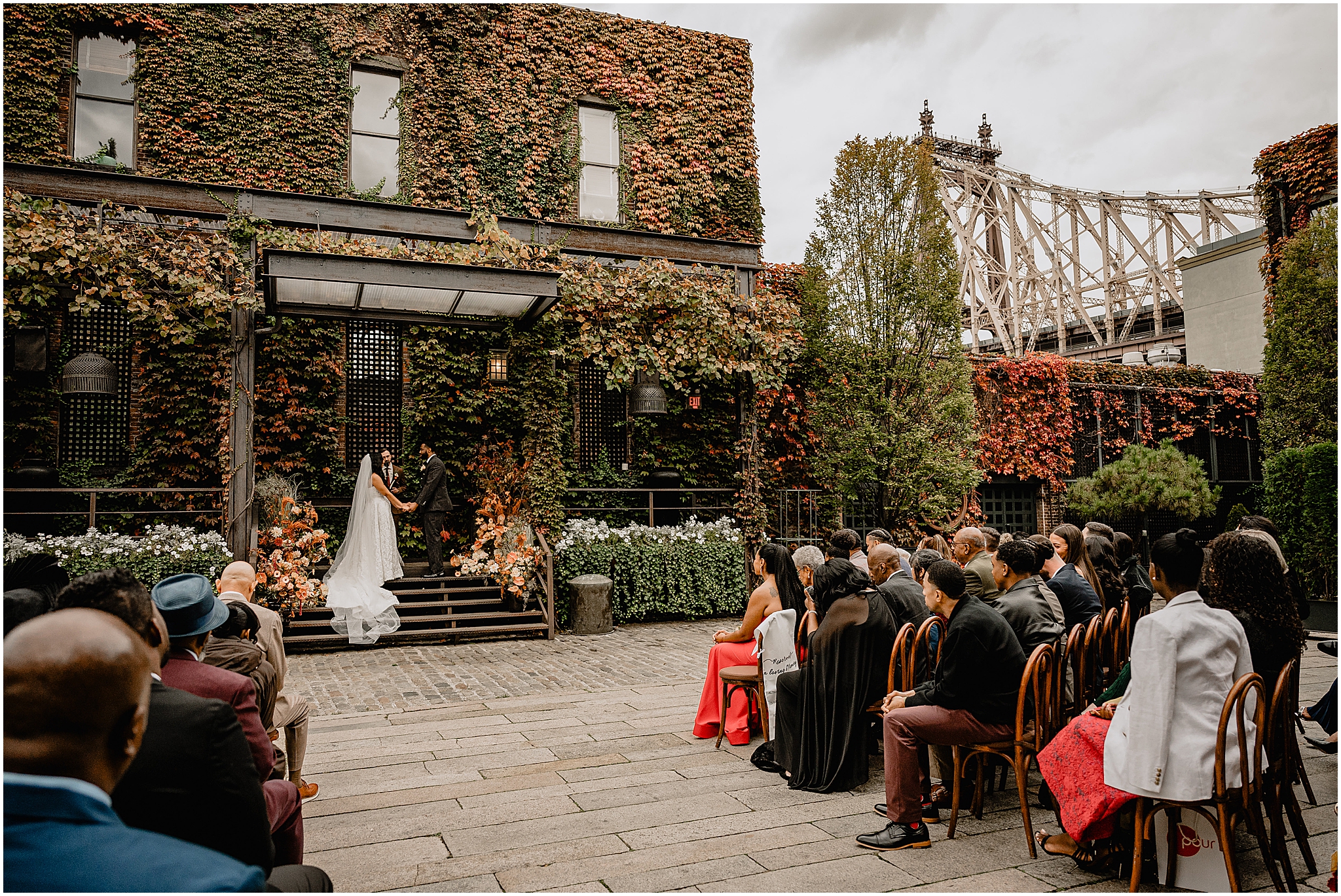 Couple at the altar during their Intimate Fall Wedding at The Foundry LIC, exchanging vows amidst the stunning autumn backdrop.