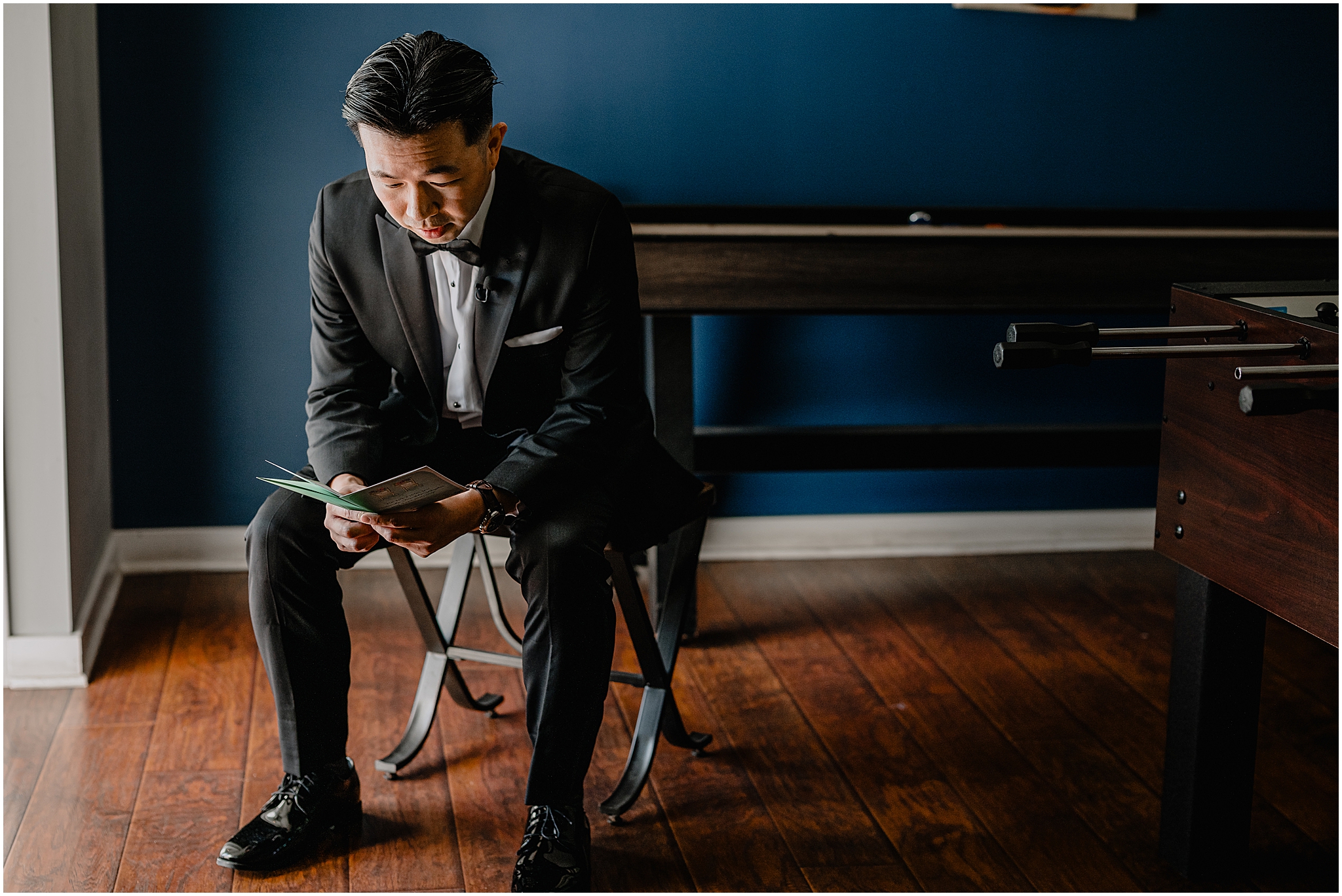 Groom reading his vows before the wedding at Perona Farms Reserve, capturing a quiet, heartfelt moment.