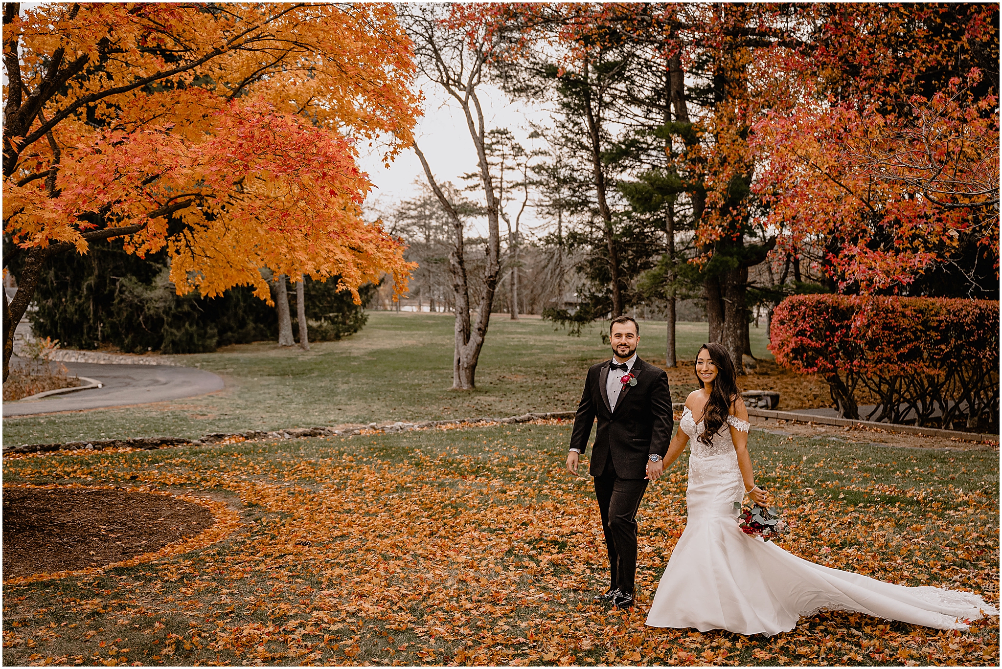 Couple’s stunning portraits in front of a beautiful autumn tree before their fall wedding at Perona Farms Refinery, bathed in soft light and surrounded by vibrant fall foliage.