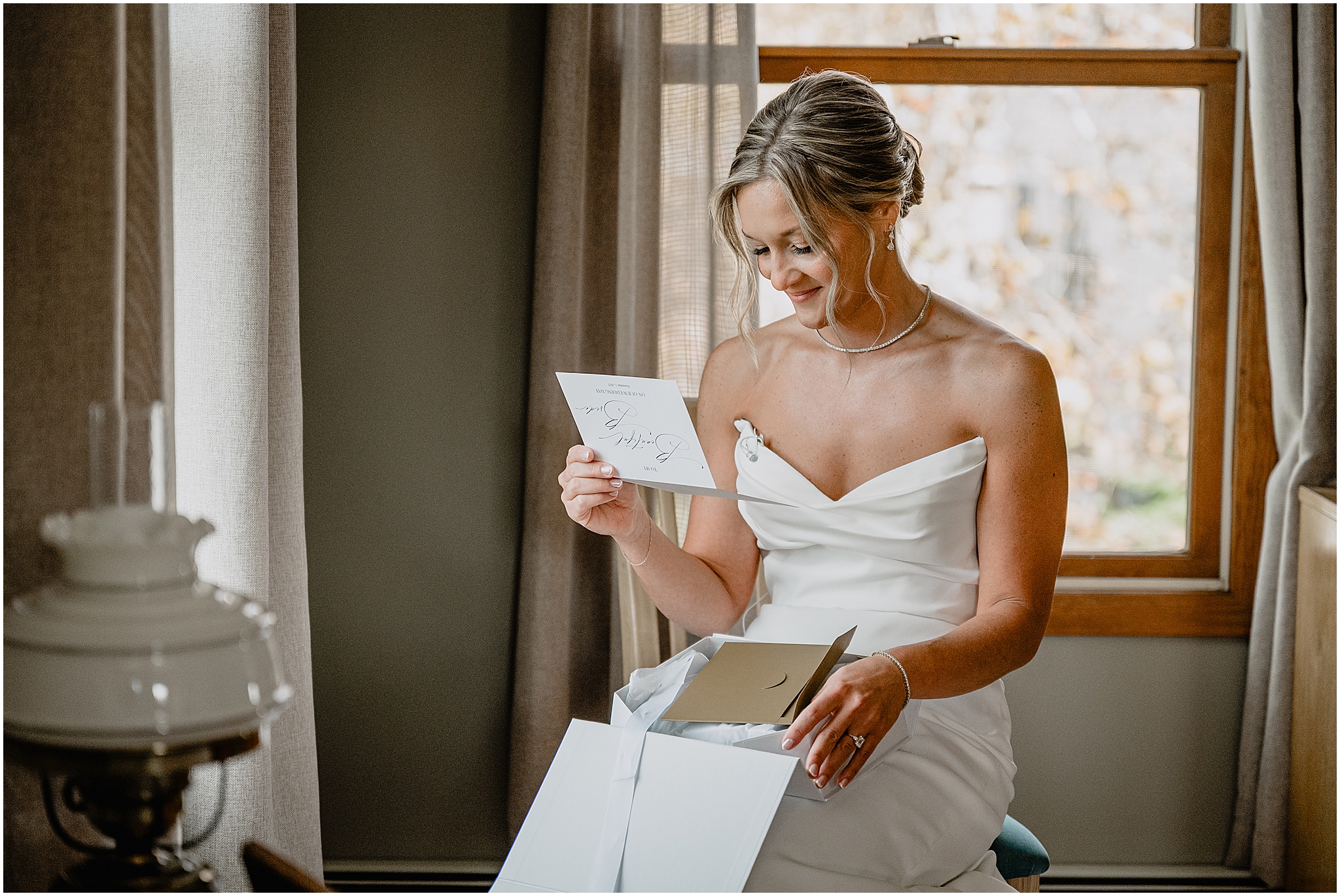 Bride reading a letter before her Westmount Country Club wedding.