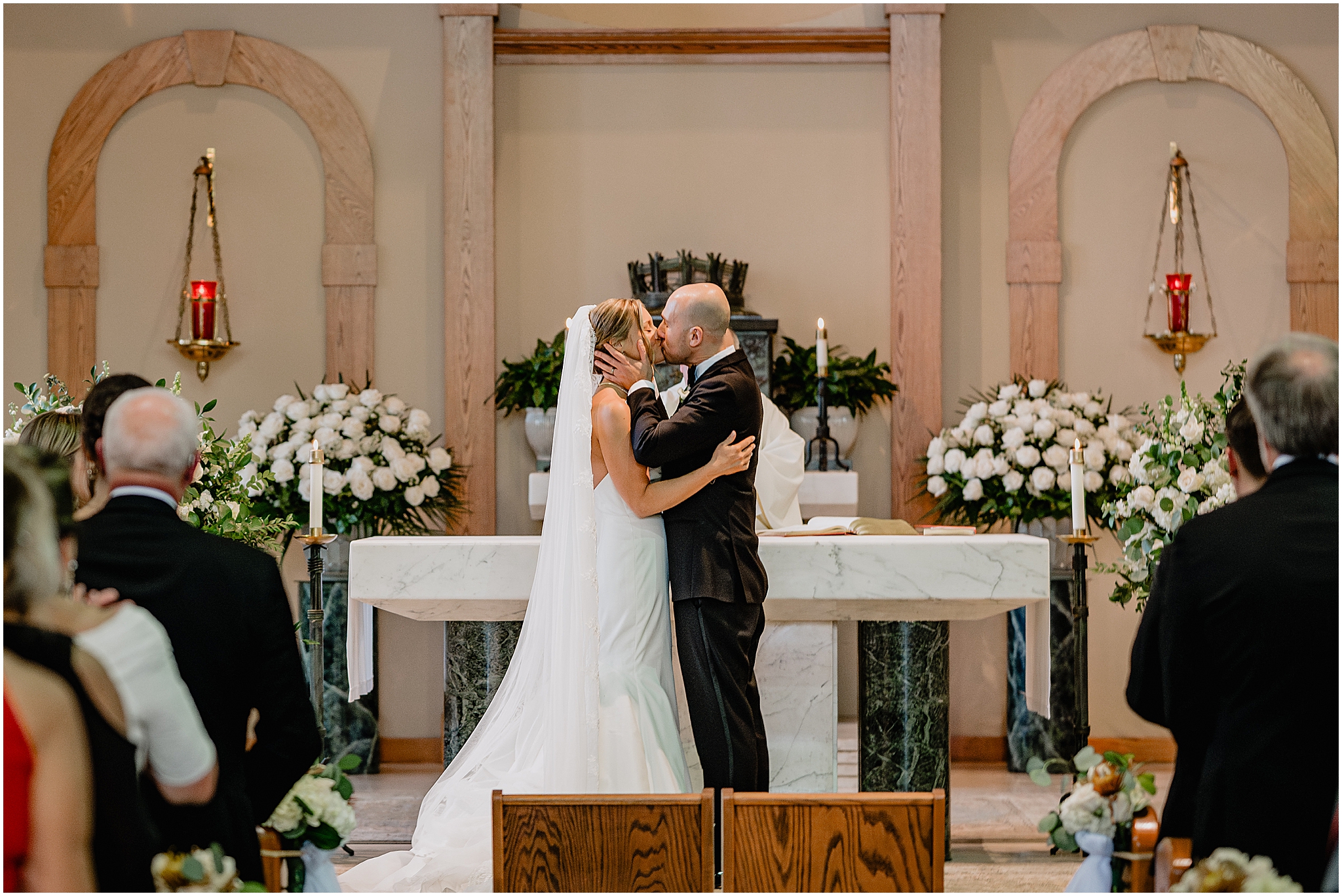 Couple sharing a kiss at the altar during their Westmount Country Club wedding, celebrating their first moments as newlyweds.
