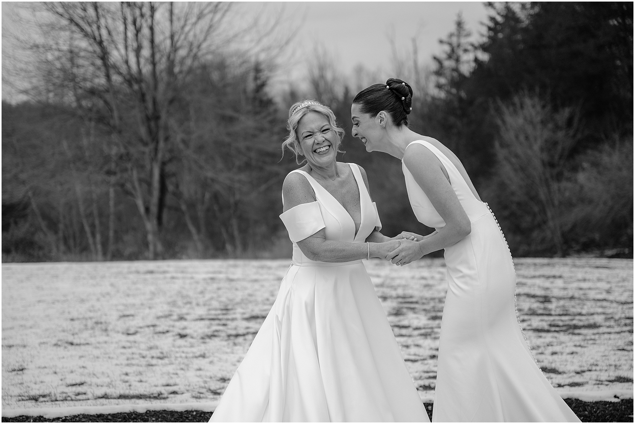 Brides laughing before their winter wedding at Crossed Keys Estate.