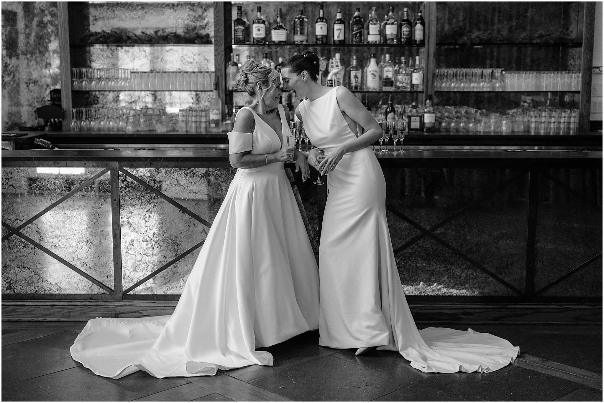 Brides by the bar before their winter wedding at Crossed Keys Estate.
