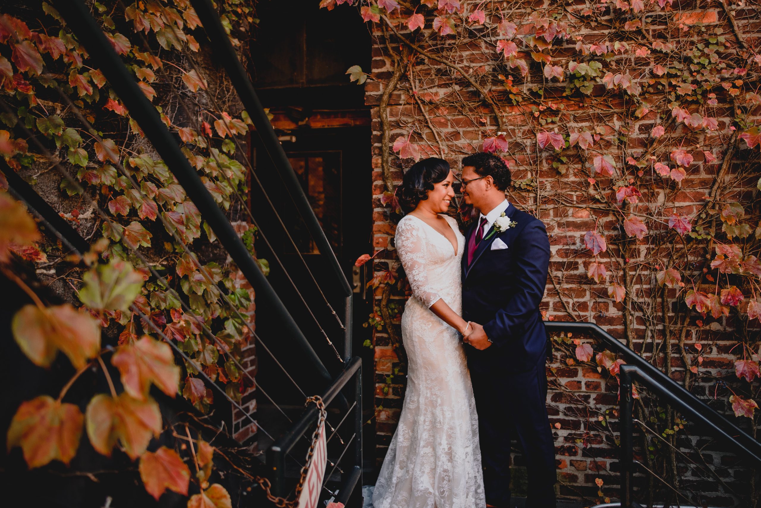 Couple by the staircase and Getting Married at The Foundry.