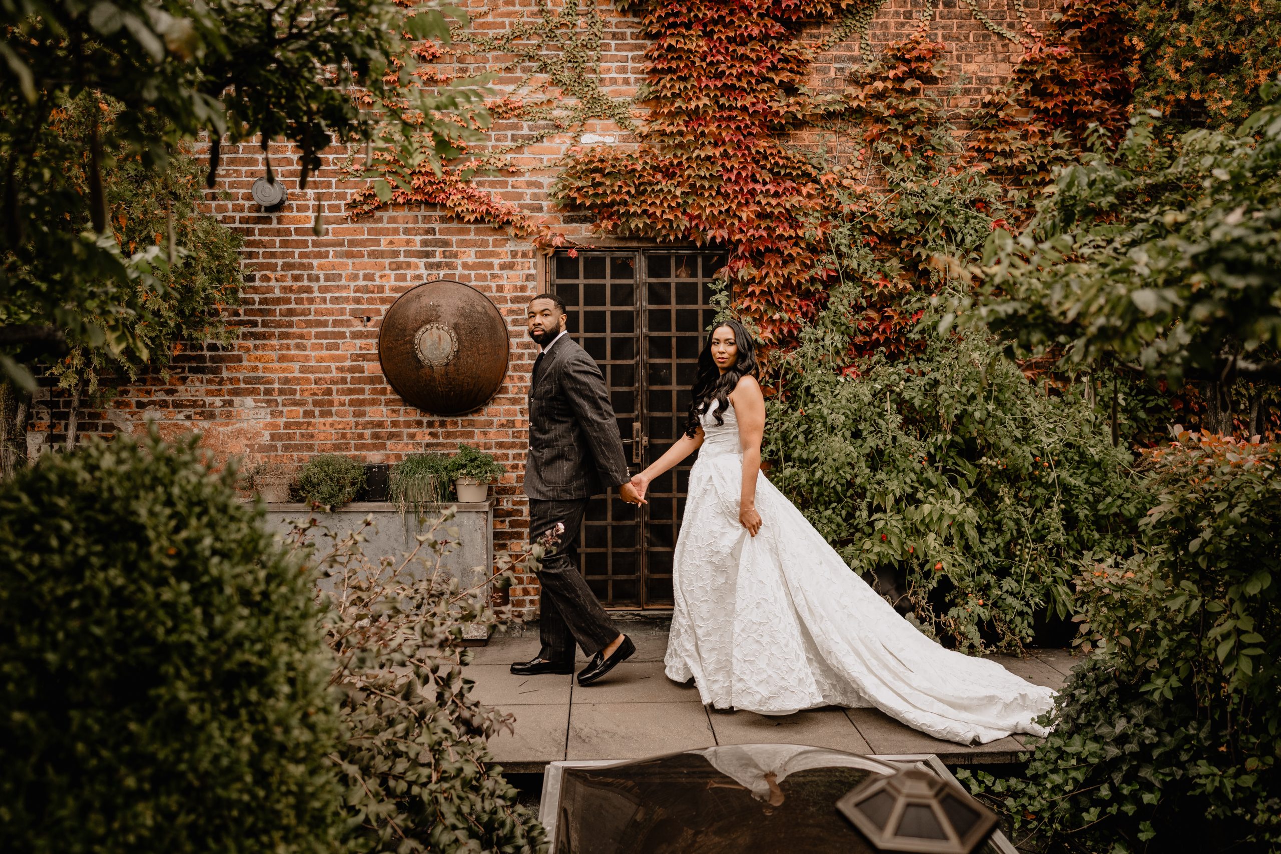 Couple walking while holding hands and Getting Married at The Foundry.