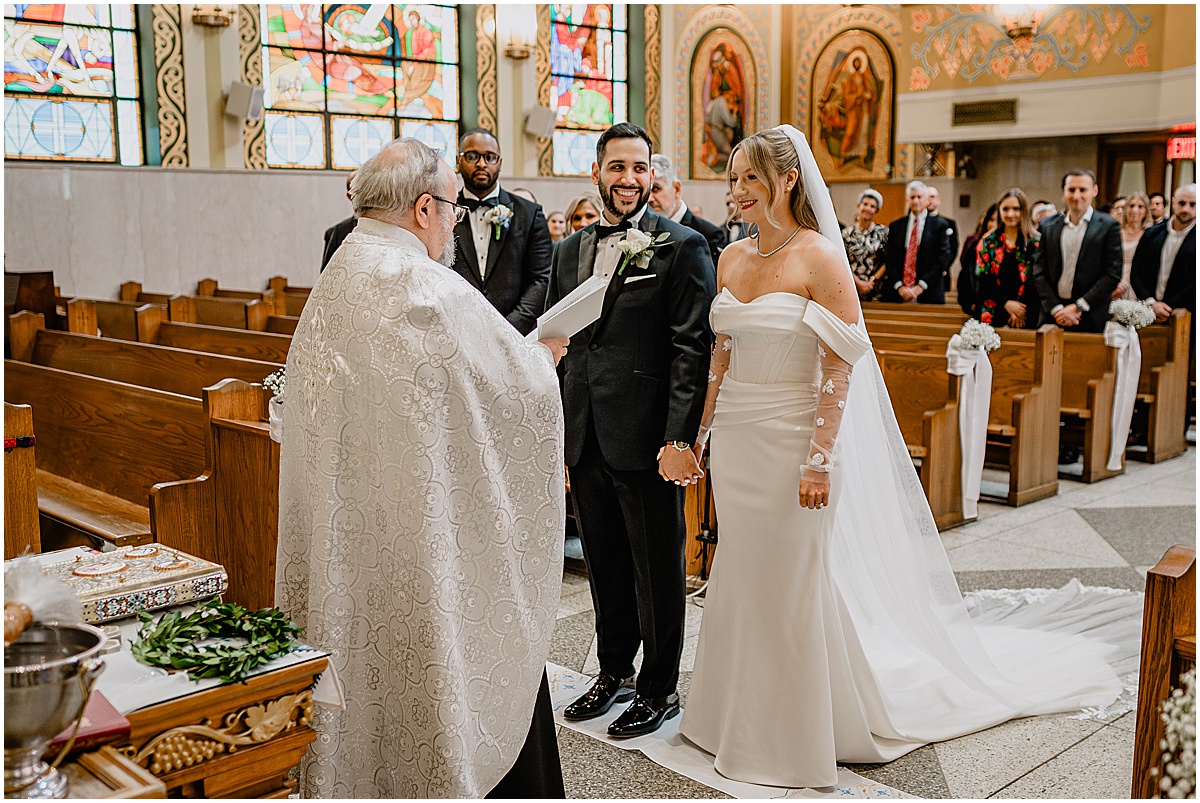 Couple at the altar during their Crossed Keys Estate winter wedding.