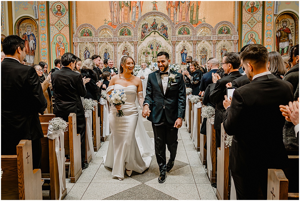 Couple walking down the aisle on their Crossed Keys Estate winter wedding.