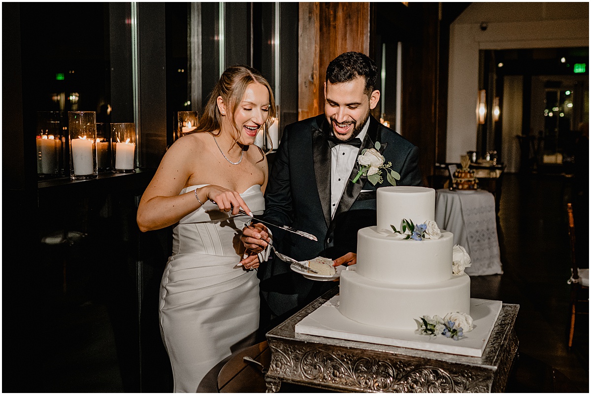 Couple slicing their cake during their Crossed Keys Estate winter wedding.