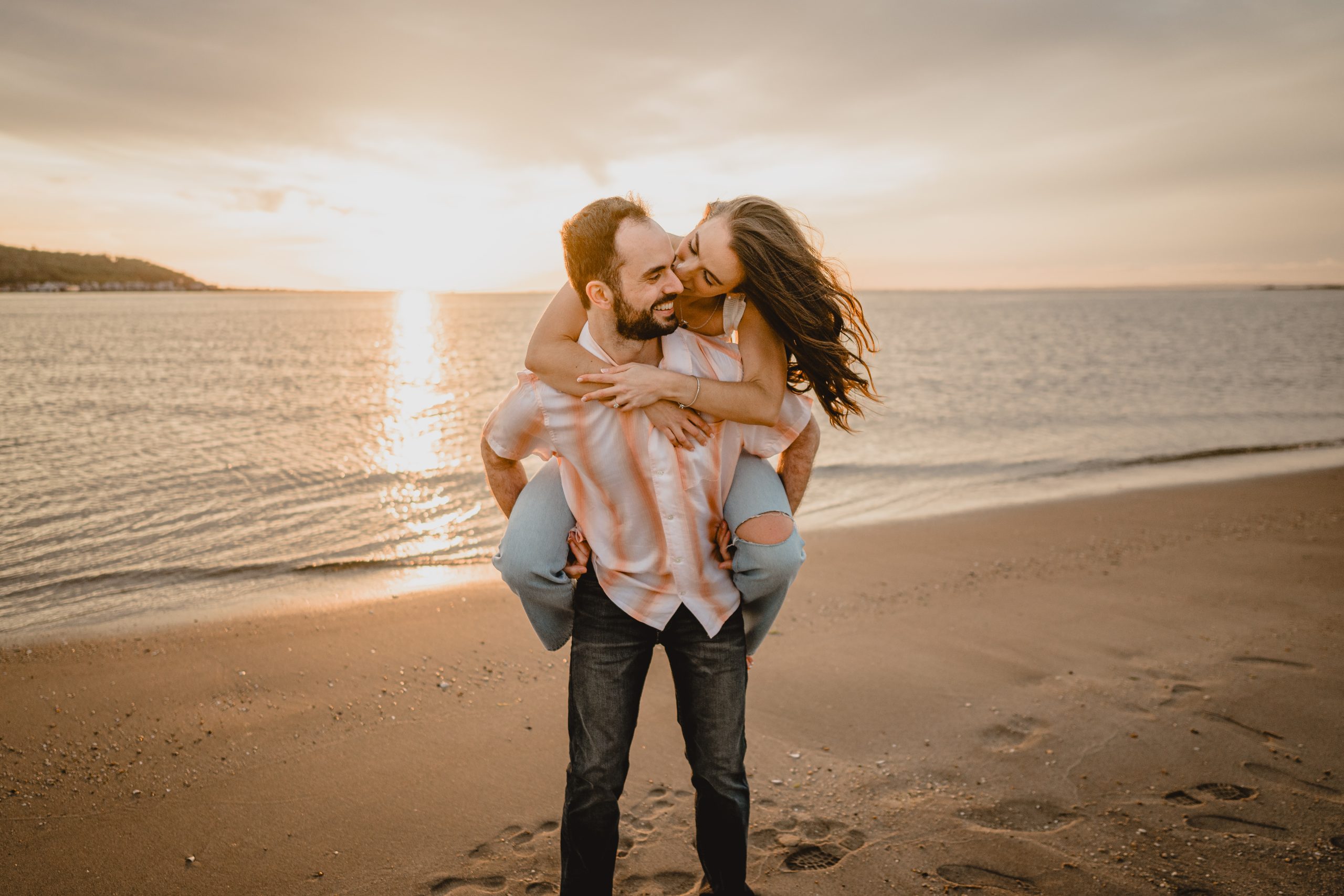 Couple by the beach during their Deep Cut Gardens and Sandy Hook engagement session.