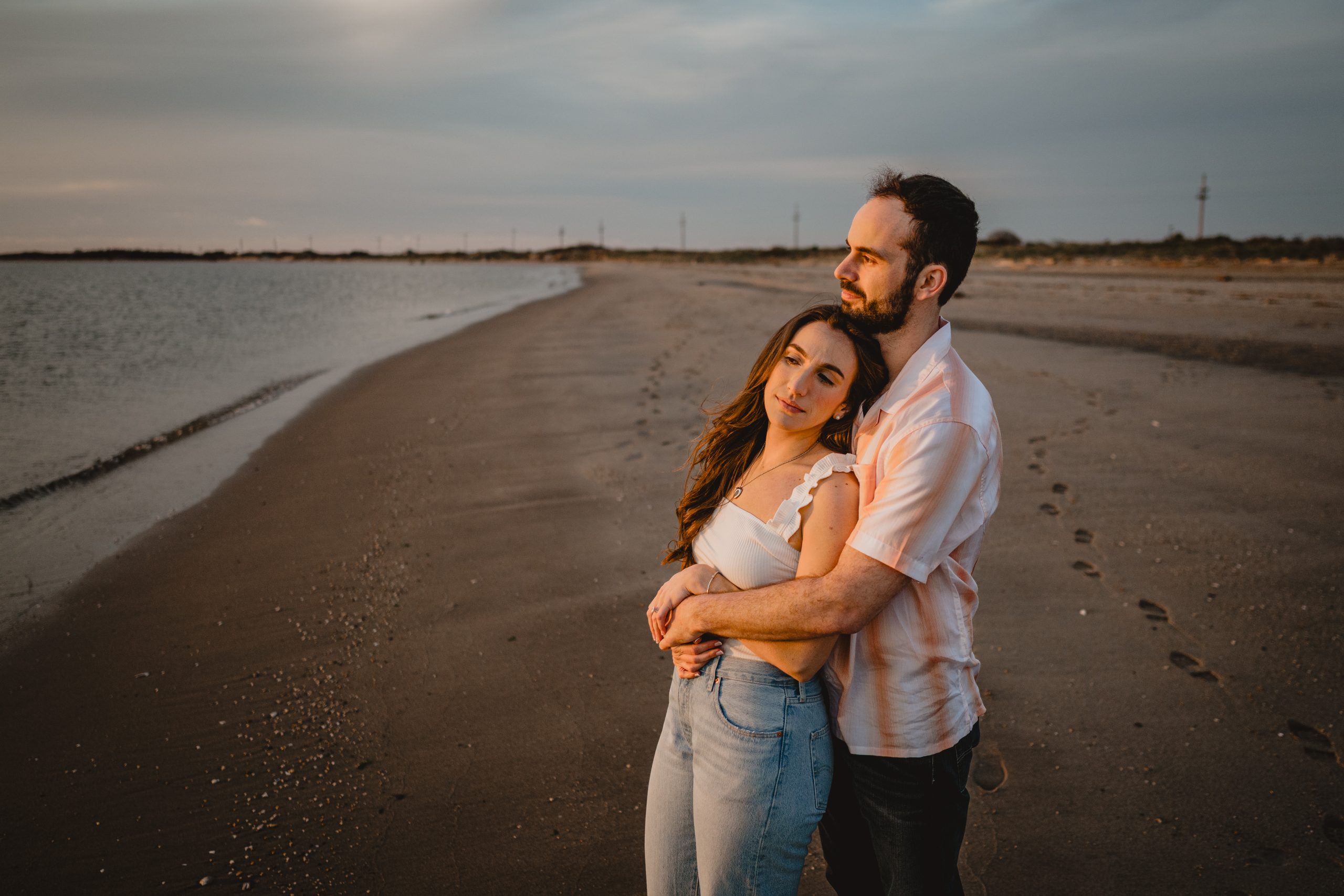 Couple by the beach during their Deep Cut Gardens and Sandy Hook engagement session.