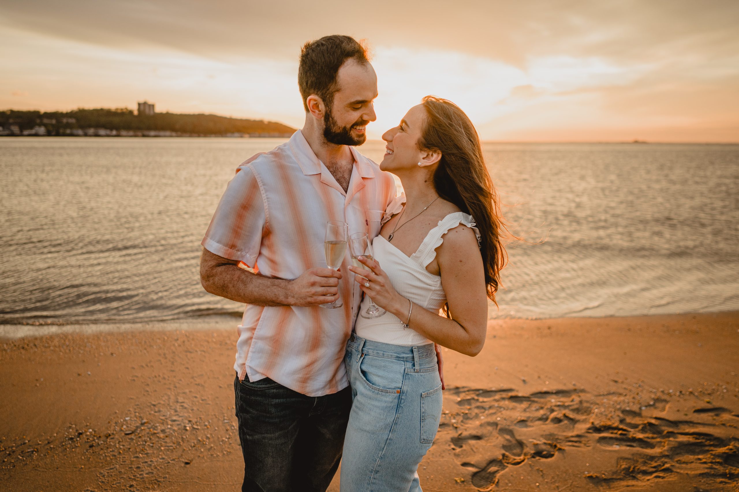 Couple making a toast during their Deep Cut Gardens and Sandy Hook engagement session.