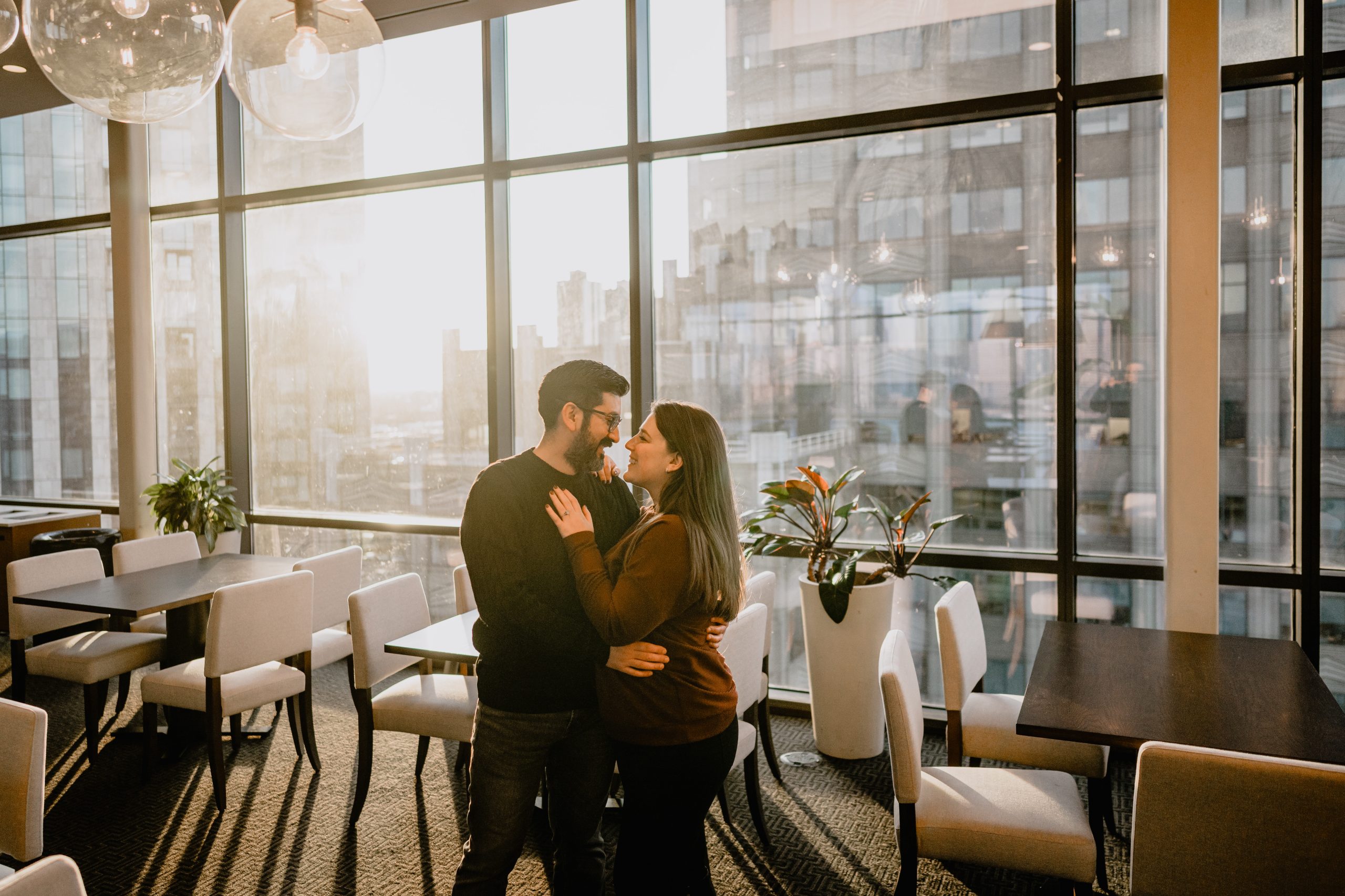 Couple hugging at their Jersey City rooftop engagement session