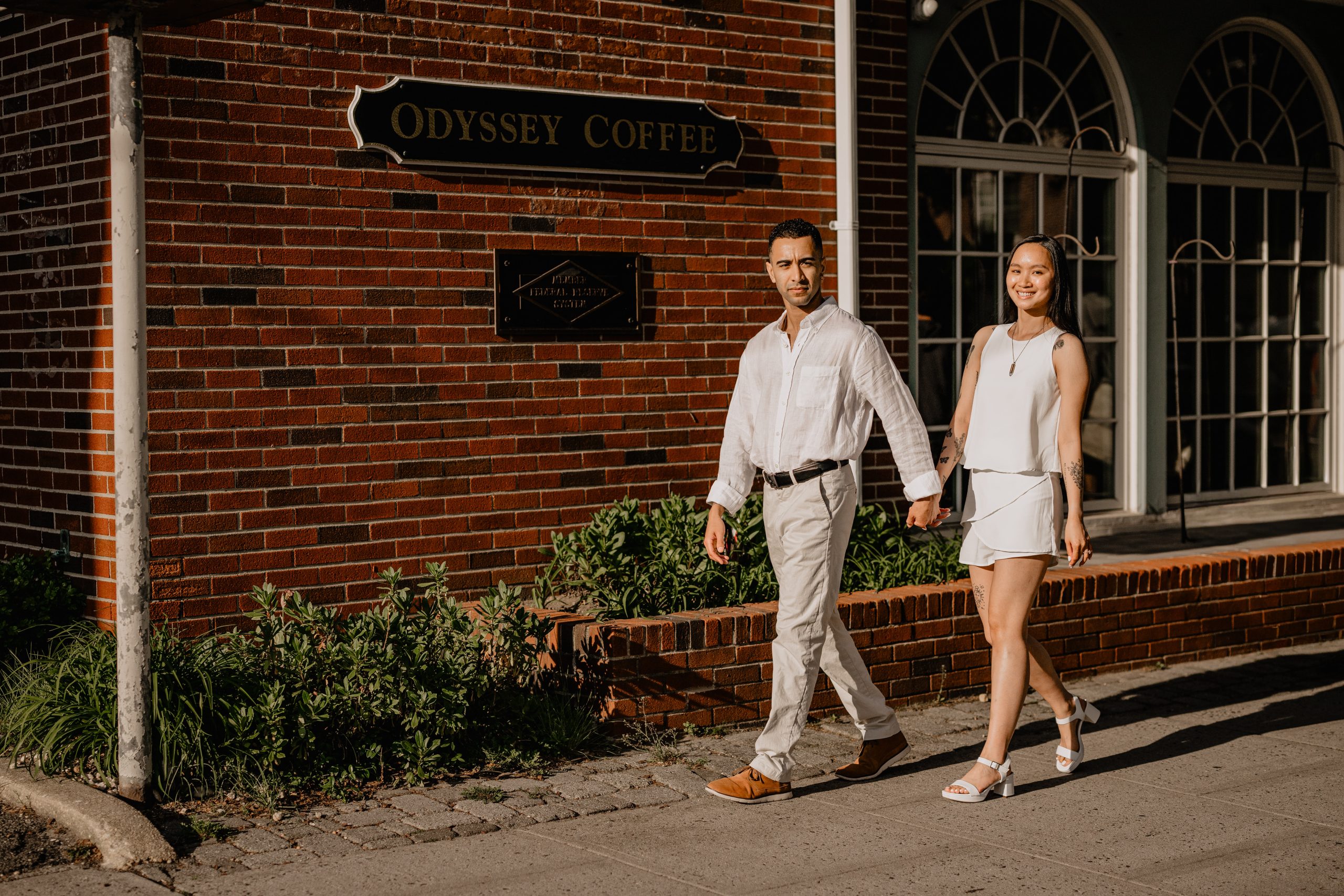 Couple walking while holding hands during their Engagement Session in Ocean Grove