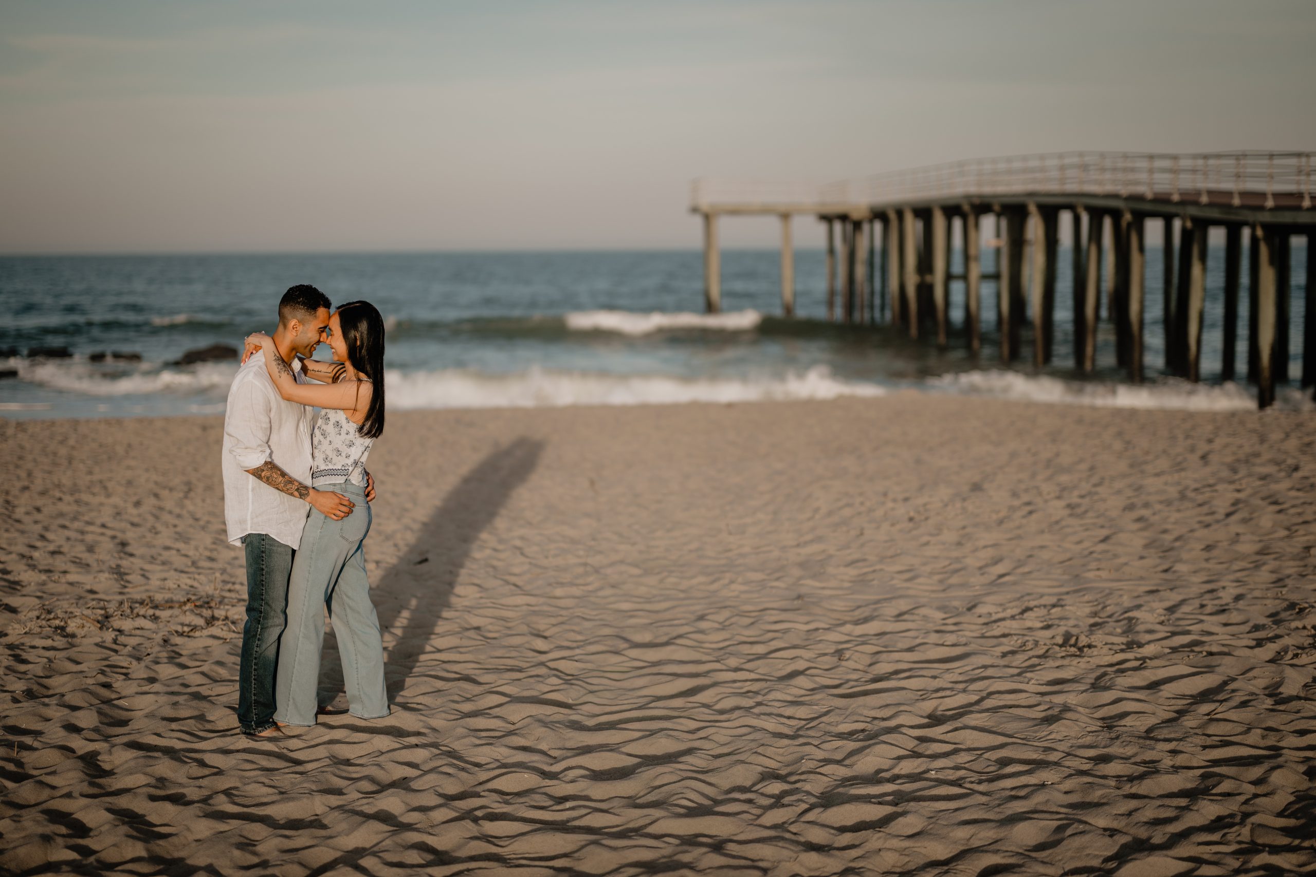 Couple by the beach during their Engagement Session in Ocean Grove